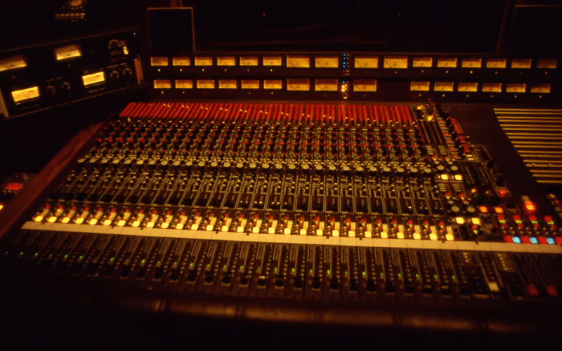 1983 MCI recording console in a dimly lit control room — classic vintage analog character