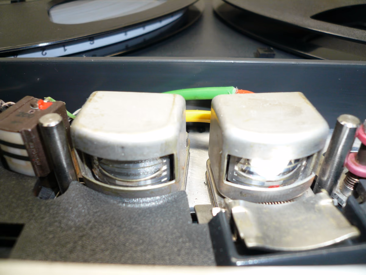 Close-up of reel-to-reel tape heads showing the tape path that creates head bump behavior