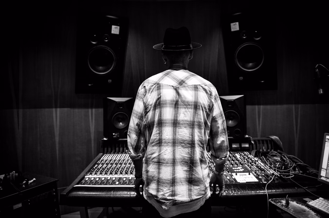 Engineer at a studio mixing desk for professional mastering workflow