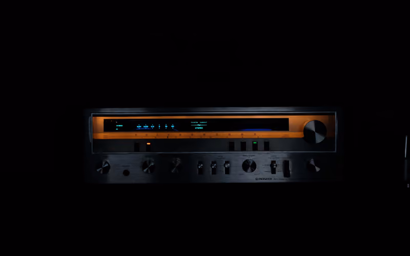 Glowing tube-style stereo amplifier representing tube saturation in mastering