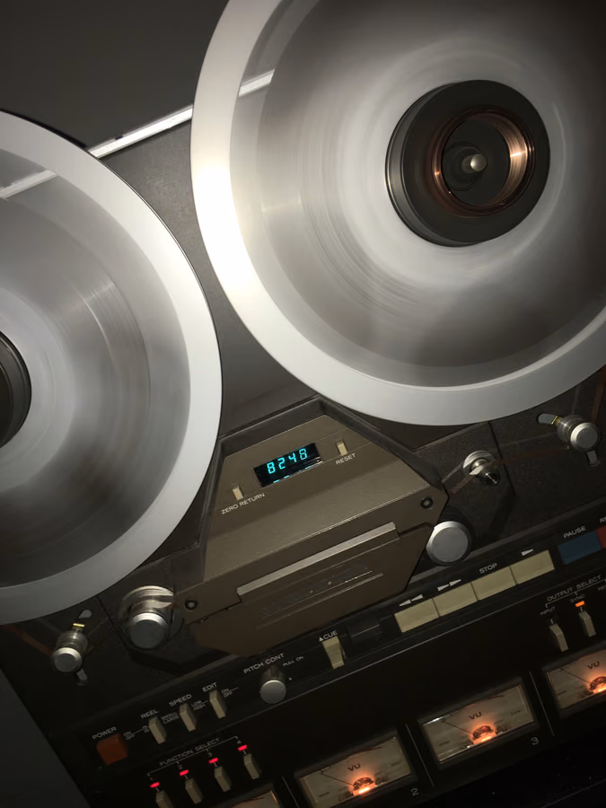 Spinning reel-to-reel tape recorder representing tape speed choices