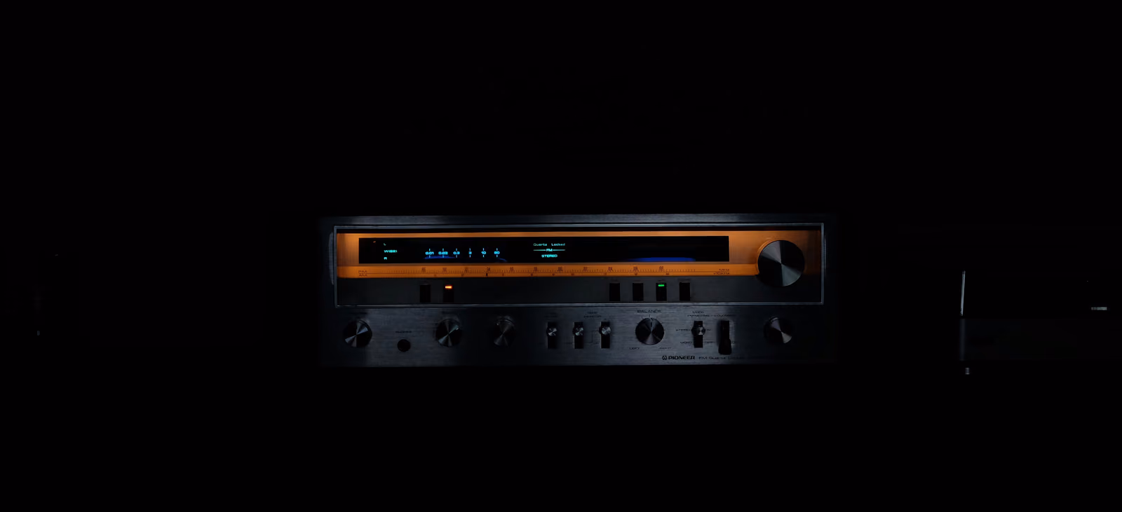 Glowing tube-style stereo amplifier representing tube saturation in mastering